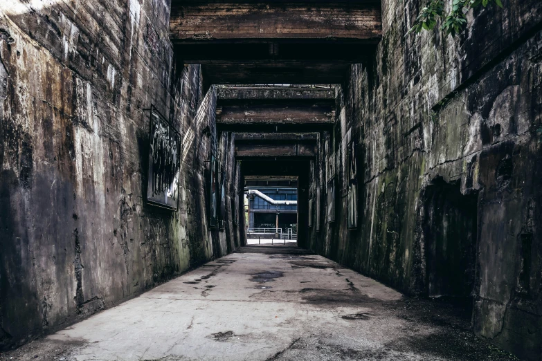 a narrow alley with graffiti on the walls, an album cover, pexels contest winner, brutalism, old lumber mill remains, dark underground, instagram photo, entrance to 1900's mine