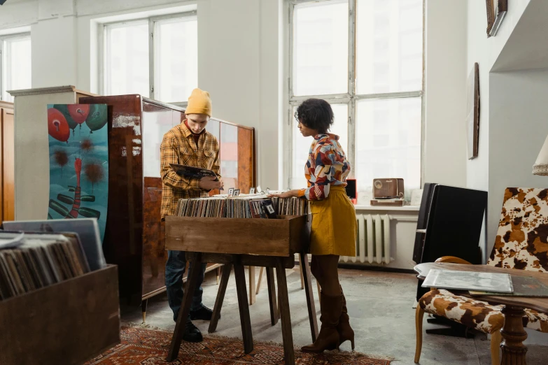 a couple of people that are standing in a room, an album cover, trending on pexels, arbeitsrat für kunst, turntables, mid-century modern furniture, vendors, maintenance photo