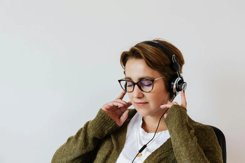 a woman sitting in front of a laptop wearing headphones, trending on pexels, hyperrealism, wearing reading glasses, avatar image, middle - age, bogna gawrońska