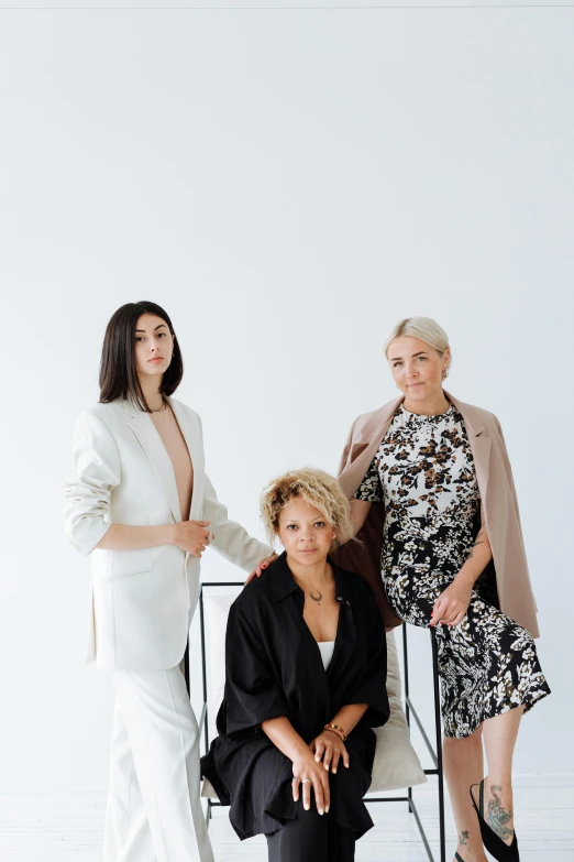 a group of women sitting next to each other, a portrait, unsplash, baroque, sleek white, trio, full product shot, multiple stories
