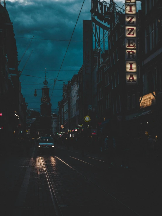 a car driving down a street next to tall buildings, an album cover, by Kristian Zahrtmann, unsplash contest winner, tonalism, dark stormy night, helsinki, street of teal stone, shops