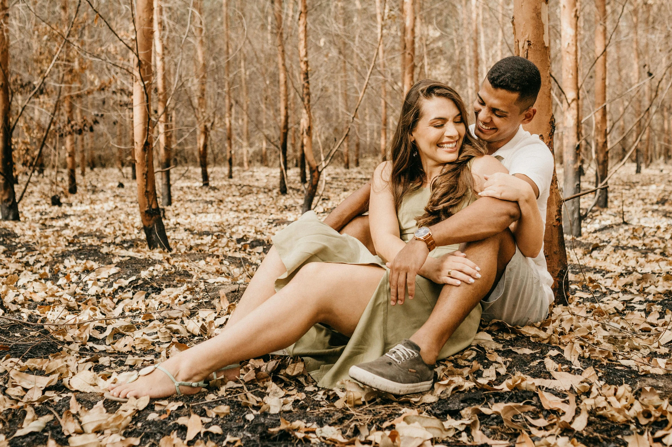 a man and woman sitting next to each other in the woods, pexels contest winner, hispanic, 🍁 cute, full body image, manuka