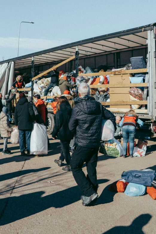 a group of people standing in front of a truck, clutter, winter sun, clothing drop, instagram post