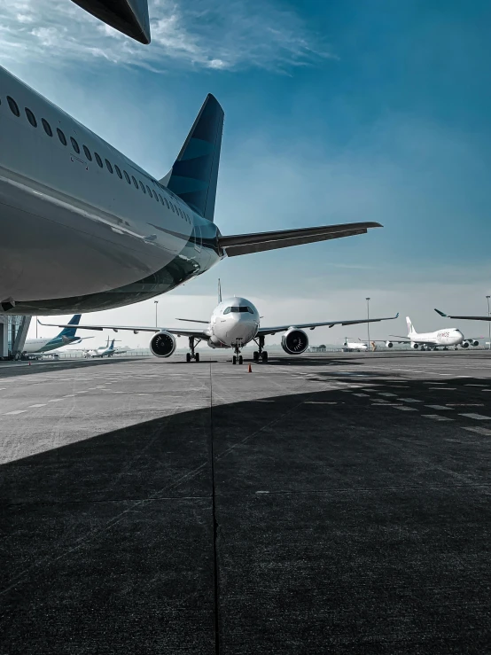 a large jetliner sitting on top of an airport tarmac, by Carey Morris, pexels contest winner, large noses, they are all laying down, high quality photo, thumbnail