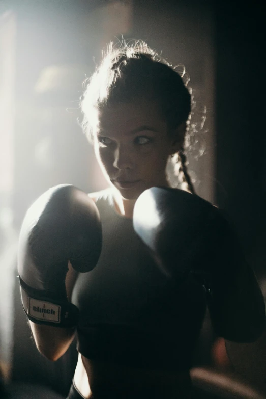 a close up of a person wearing boxing gloves, a portrait, pexels contest winner, hailee steinfeld, backlight body, performance, adriana lima