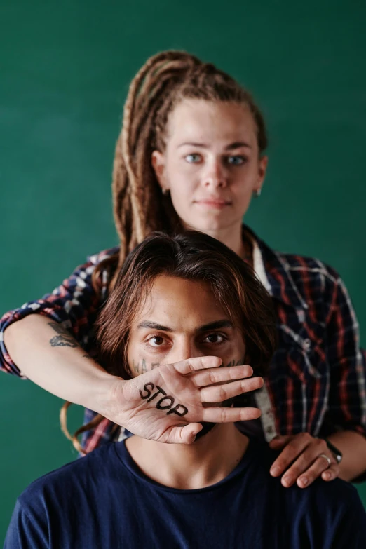 a woman covering a man's face with his hands, a tattoo, trending on unsplash, antipodeans, frank dillane as puck, yearbook photo, lesbian, indigenous