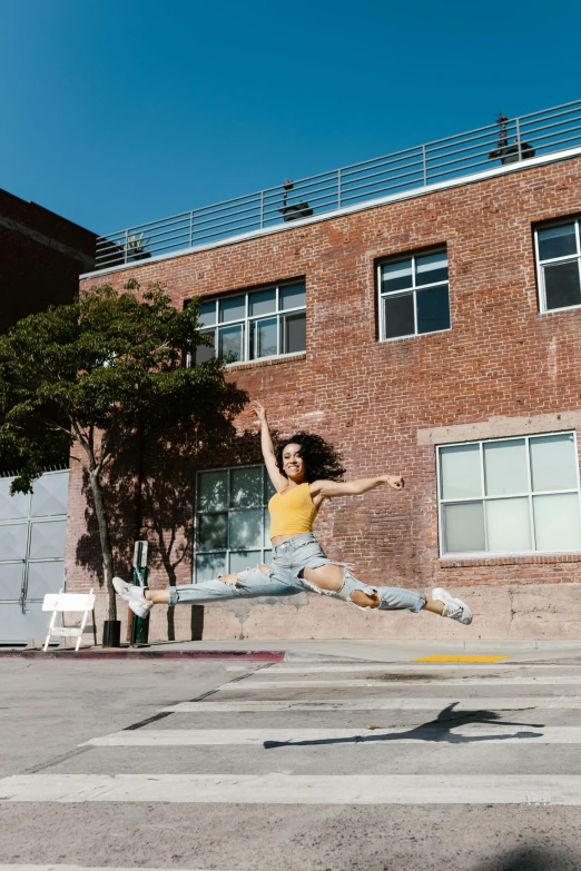 a man flying through the air while riding a skateboard, by Nina Hamnett, arabesque, photo of the beauty gal gadot, in front of a garage, san francisco, promo image