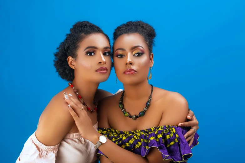 a couple of women standing next to each other, a portrait, by Chinwe Chukwuogo-Roy, pexels, blue jewellery, with afro, various posed, square