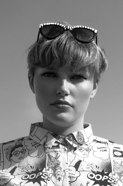 a black and white photo of a woman wearing sunglasses, by Lee Loughridge, taylor swift as a boy, patterned clothing, thick neck, andree wallin
