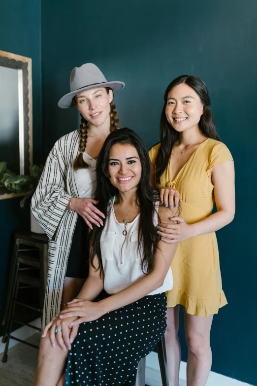 three women standing next to each other in front of a mirror, a portrait, trending on unsplash, sitting on a mocha-colored table, joanna gaines, gorgeous female jade tailor, mai anh tran