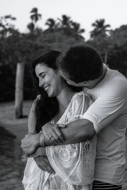 a black and white photo of a man hugging a woman, a black and white photo, pexels contest winner, instagram post, summer setting, smiling playfully, hispanic