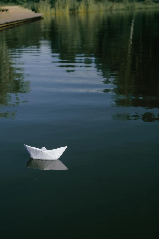 a paper boat floating on top of a lake, by Attila Meszlenyi, paul barson, photograph, barbara canepa, contain