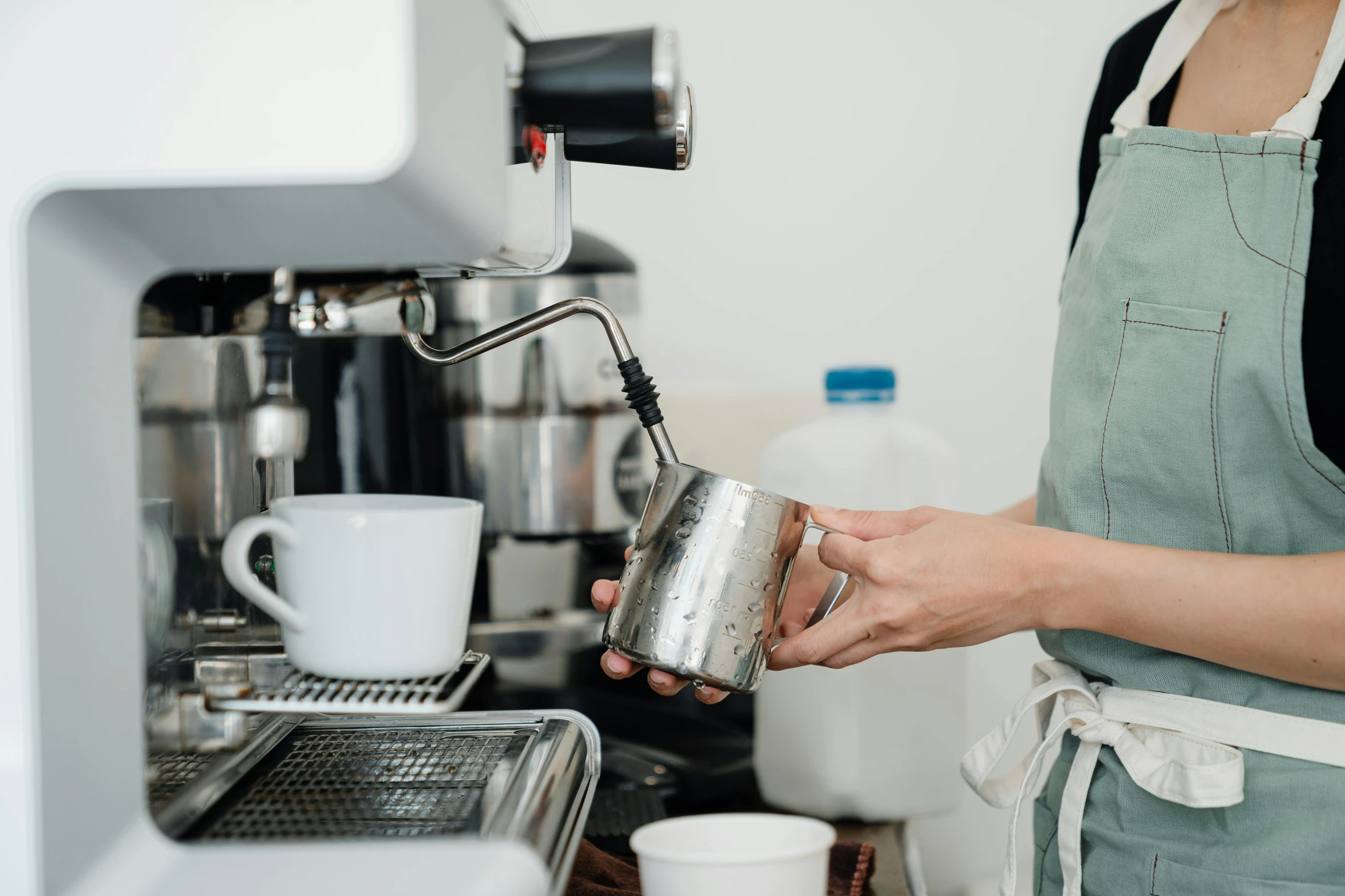 a woman is pouring a cup of coffee, pexels, stainless steel, mechanised, lachlan bailey, in detail