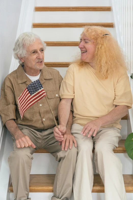 a man and a woman sitting on a set of stairs, by Alison Geissler, trending on reddit, patriotic, curly white hair, dementia, lesbians