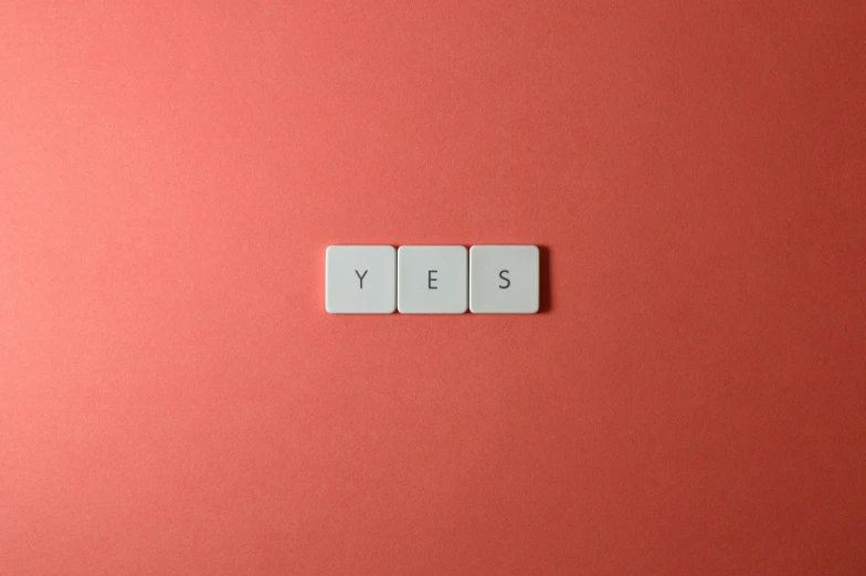 the word yes spelled with white tiles on a red background, by Emma Andijewska, pexels contest winner, aestheticism, panel, gray, pink, frank moth