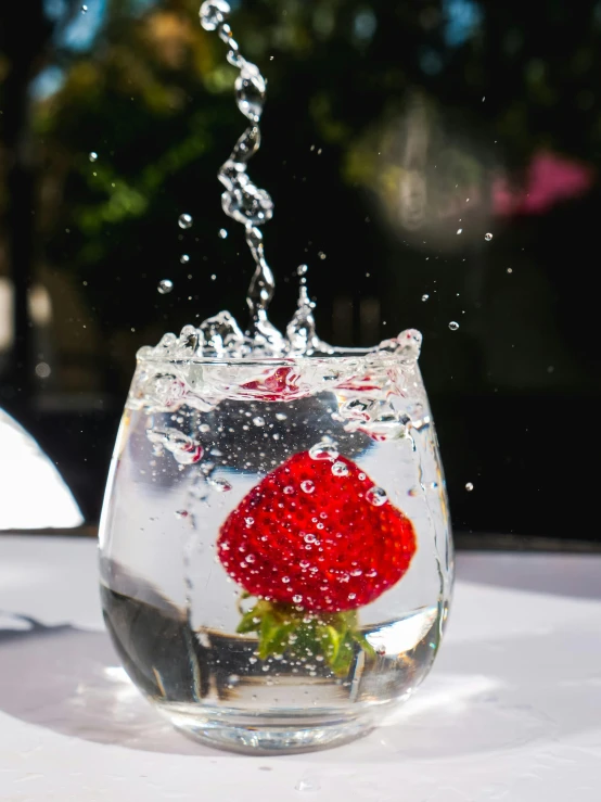 a glass of water with a red rose in it, unsplash, strawberry, promo image, sparkling water, profile image