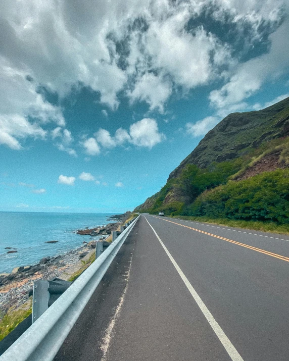 a car driving down a road next to the ocean, hills and ocean, thumbnail, beautiful image, taiwan