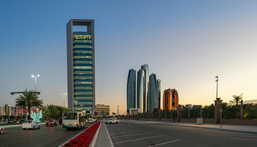 a street filled with lots of traffic next to tall buildings, pexels contest winner, hyperrealism, arabia, square, calm evening, three towers