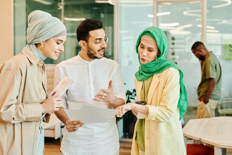 a couple of people that are talking to each other, hurufiyya, in an office, wearing a head scarf, a group of people, ui and ux