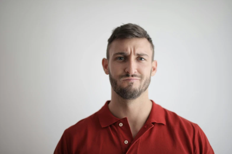 a man in a red shirt posing for a picture, disappointed, rectangle, short beard, portrait image