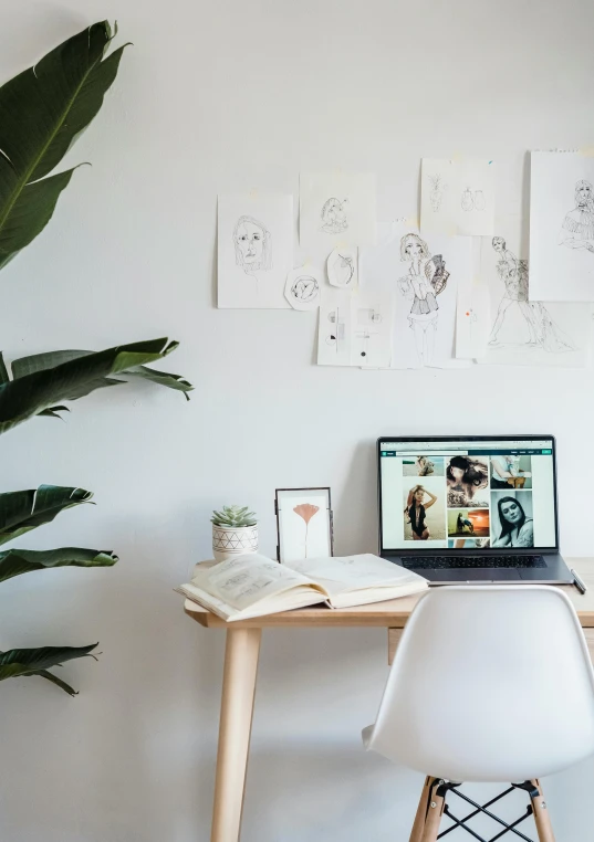 a laptop computer sitting on top of a wooden desk, a picture, trending on pexels, interior white wall, 9 9 designs, portait photo, well - drawn