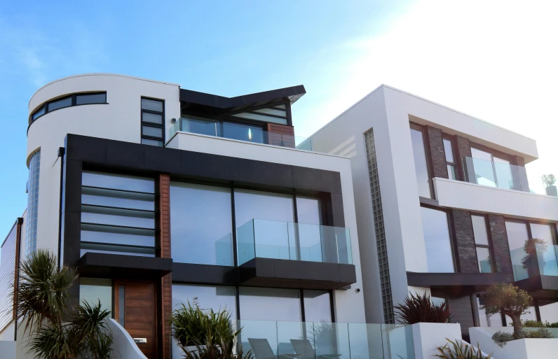 a black and white house on a sunny day, a digital rendering, unsplash, modernism, balconies, coper cladding, seaview, angular and altermodern