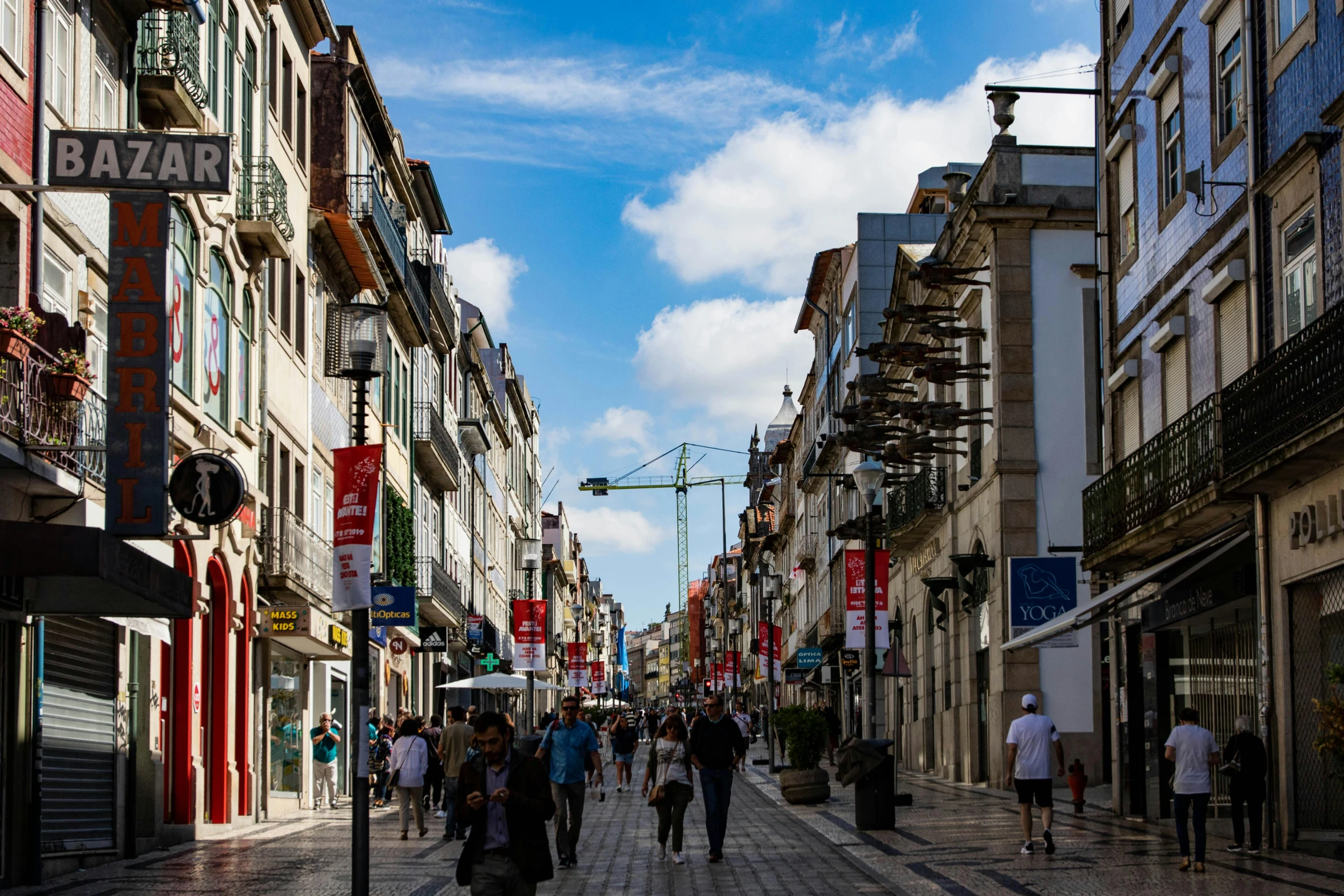 a group of people walking down a street next to tall buildings, by Juan Giménez, pexels contest winner, renaissance, nazare (portugal), lots of signs and shops, square, a small