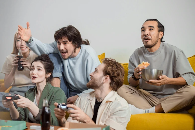 a group of people sitting on top of a yellow couch, eating chips and watching tv, avatar image, playing games, attractive photo