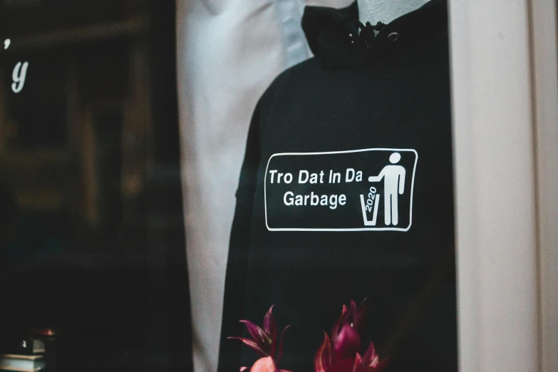 a close up of a shirt on a mannequin mannequin mannequin mannequin mannequin mannequin manne, a poster, trending on unsplash, graffiti, wearing a hoodie and flowers, wearing a black t-shirt, trash can, avatar image