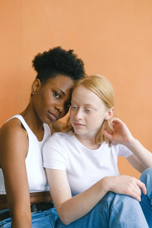 a couple of women sitting next to each other, by Arabella Rankin, trending on pexels, renaissance, pale orange colors, black teenage boy, lesbian embrace, ginger hair
