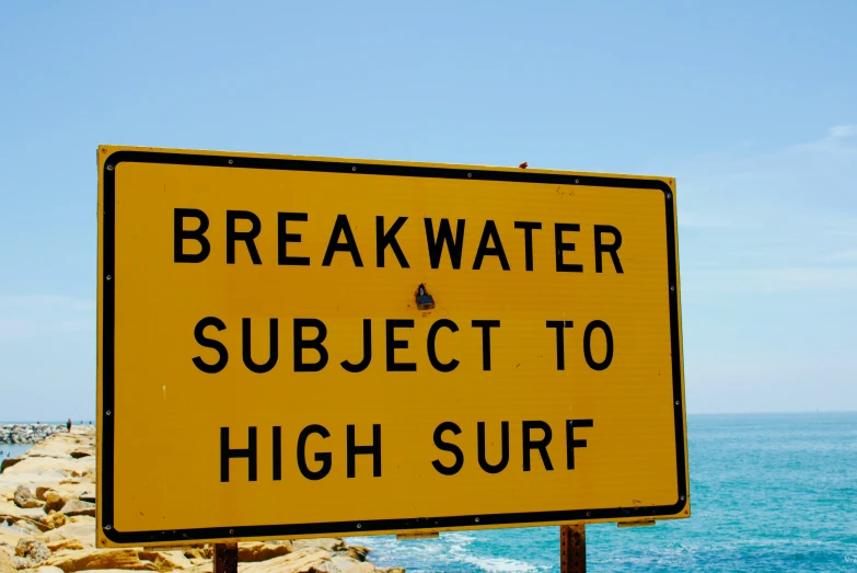 a yellow sign that says breakwater subject to high surf, by Bertram Brooker, shutterstock, high elevation, breakfast, sydney, tournament