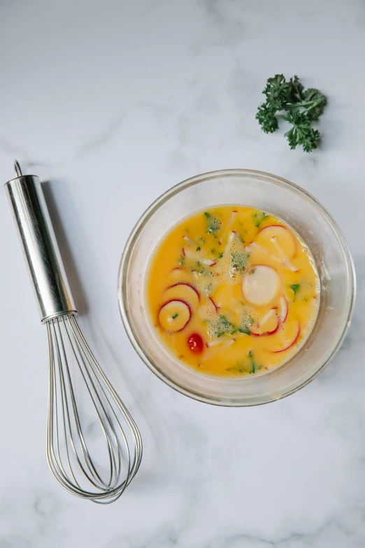 a bowl of soup with a whisk next to it, reddit, tropical, professional product photo, overcast, diego koi