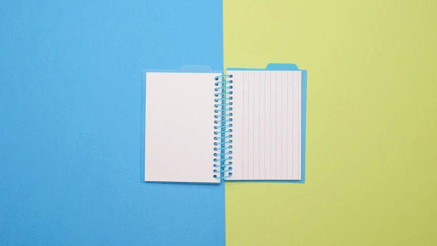 an open notebook on a blue and green background, pexels, two tone, diecut, adorable design, bright colorful