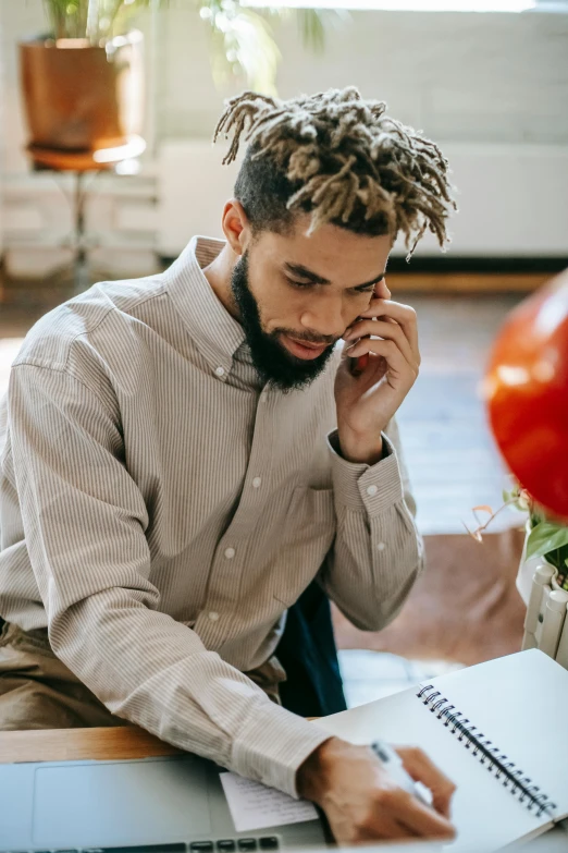 a man sitting on the floor talking on a cell phone, trending on pexels, lawther sit at table playing dnd, ashteroth, serious business, man holding a balloon