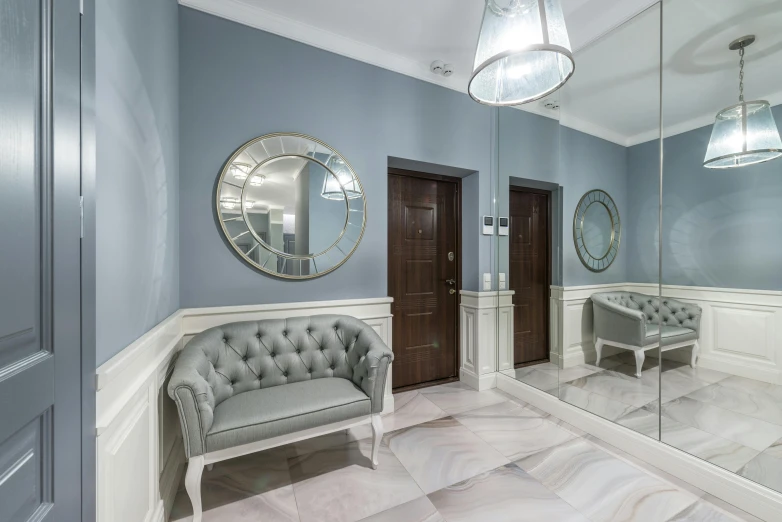 a living room filled with furniture and a mirror, grey and blue theme, elevator, profile image, hallway