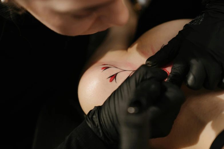 a woman getting a tattoo on her chest, a tattoo, by Adam Marczyński, trending on pexels, thin red veins, tattoo stencil, 1614572159, body painted with black fluid