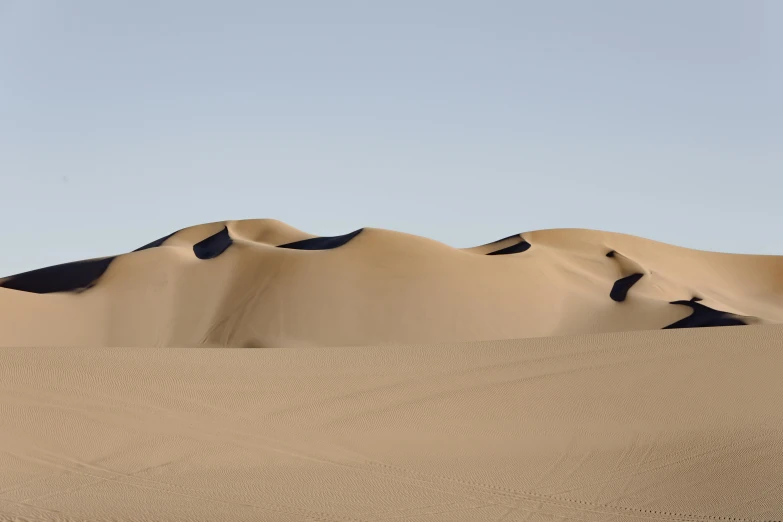 a person riding a horse in the desert, an album cover, inspired by Scarlett Hooft Graafland, unsplash contest winner, curved lines, nadav kander, dune (2021), archival pigment print