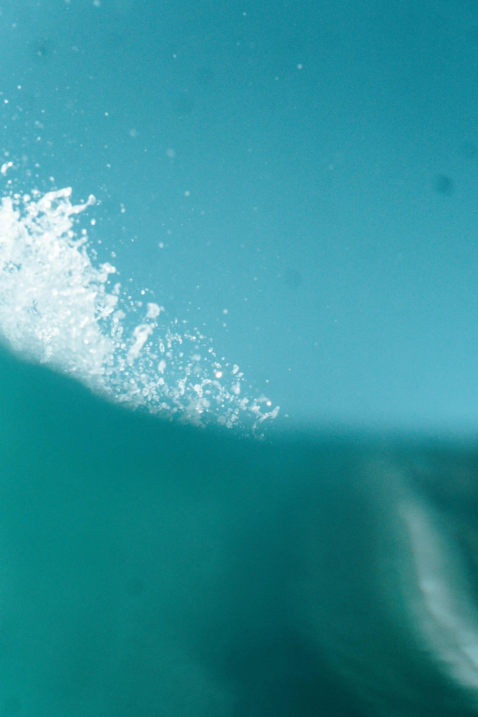 a man riding a wave on top of a surfboard, unsplash, minimalism, wave of water particles, 4 k close up, teal, slide show