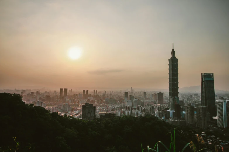 a view of a city from the top of a hill, inspired by Zhang Kechun, pexels contest winner, art nouveau, taiwan, evening sun, outdoors tropical cityscape, towering