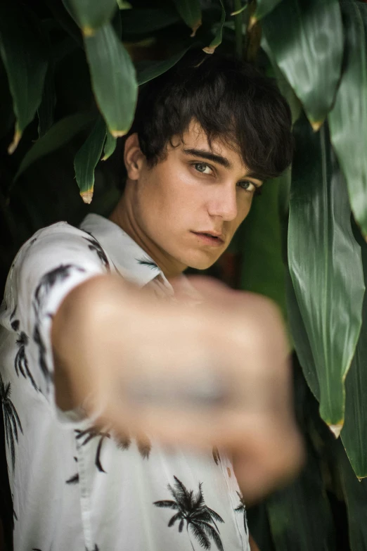a young man pointing his finger at the camera, an album cover, by Cosmo Alexander, pexels contest winner, non binary model, jungle, ana de la reguera portrait, greens)