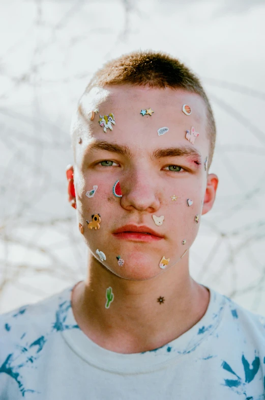 a young man with a lot of stickers on his face, an album cover, trending on pexels, hyperrealism, white freckles, justin sun, bladee from drain gang, julian ope