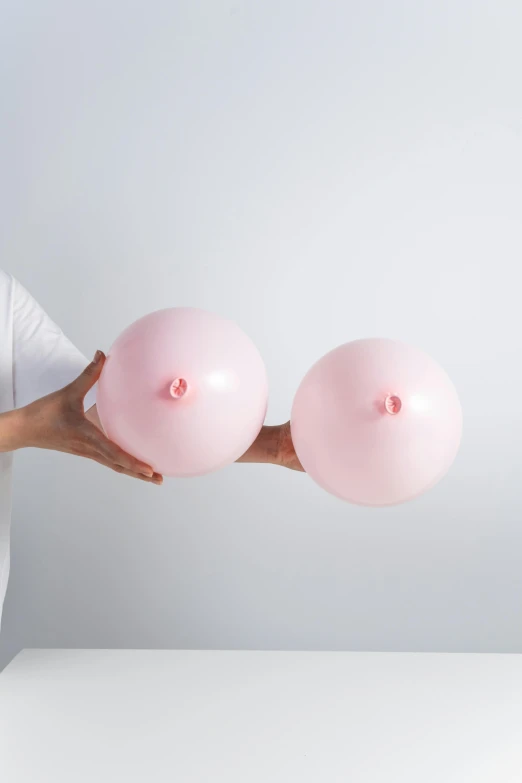 a woman holding two pink balloons in front of her face, inspired by Zhang Kechun, trending on unsplash, plasticien, large breasts size, posable pvc, bottom - view, detailed product image