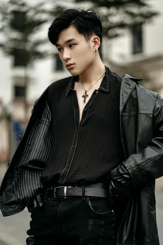 a man in a black shirt and leather jacket, an album cover, inspired by Zhang Han, trending on pexels, realism, attractive androgynous humanoid, street pic, beads cross onbare chest, fashion model