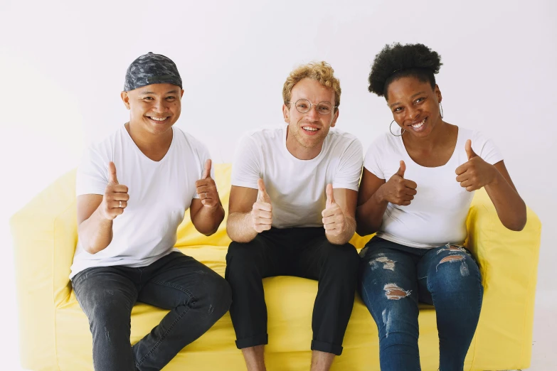 three women sitting on a yellow couch with thumbs up, pexels contest winner, antipodeans, blonde guy, varying ethnicities, an all white human, teenage boy