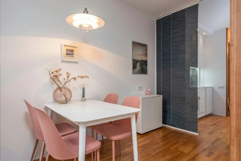 a dining room with a white table and pink chairs, by Adam Marczyński, unsplash, light and space, fan favorite, small and cosy student bedroom, single floor, flat minimalistic