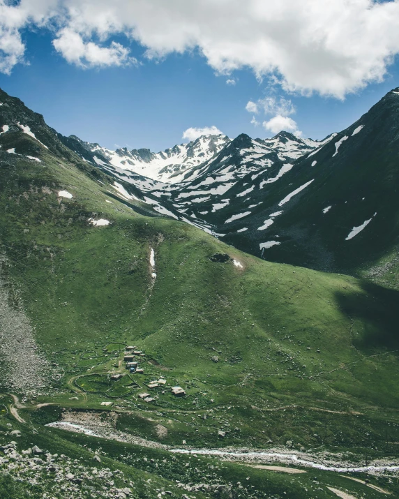 a man riding a horse on top of a lush green hillside, pexels contest winner, les nabis, glaciers, mountain valley to factory, with snow on its peak, the place is just really small