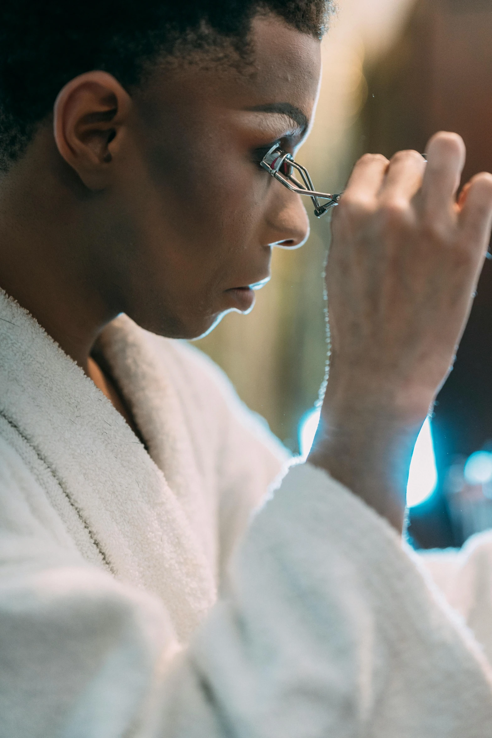 a close up of a person in a bathrobe, inspired by Barthélemy Menn, pexels contest winner, happening, wears oprah glasses, praying, shaven, african american woman