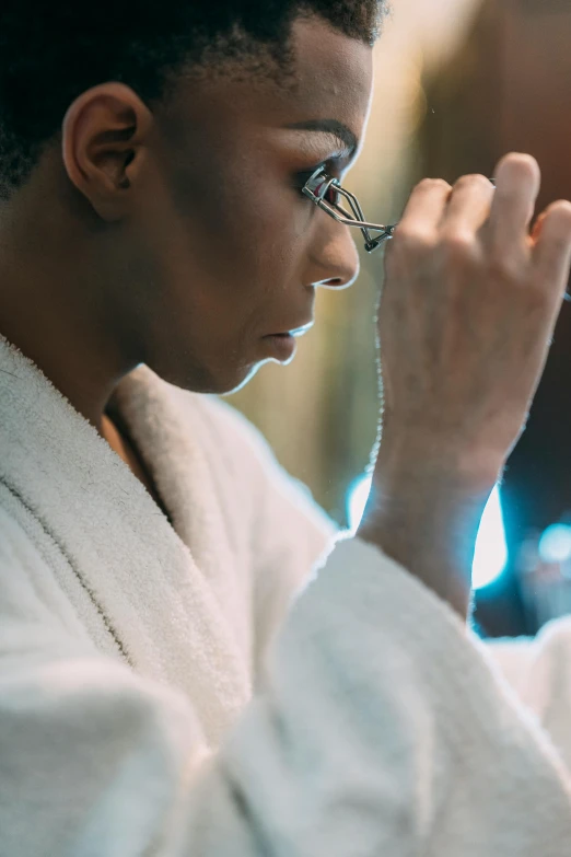 a close up of a person in a bathrobe, inspired by Barthélemy Menn, pexels contest winner, happening, wears oprah glasses, praying, shaven, african american woman