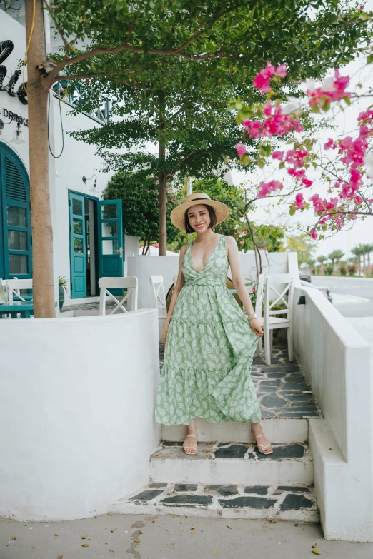 a woman wearing a green dress and a straw hat, inspired by Theophanes the Greek, pexels contest winner, standing outside a house, resort, dressed in a flower dress, ana de armas