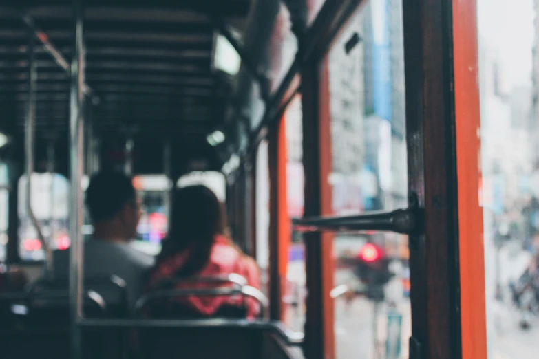 a couple of people sitting on top of a bus, pexels contest winner, out of focus, 🚿🗝📝, trams ) ) ), view from inside